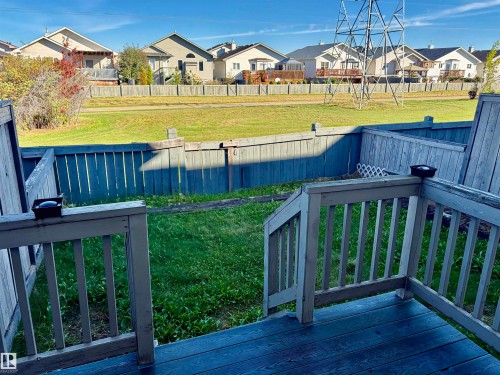 Wooden deck with a railing and steps to the backyard - #17 16317 64 St Nw, Edmonton, AB 