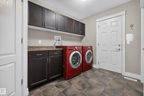 Dark wood-finish cabinetry with contrasting hardware - 1850 Rutherford Road Sw, Edmonton, AB 