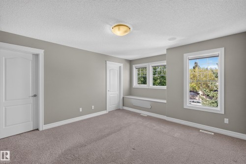 Recessed lighting, carpet flooring, multiple windows, built-in window bench, and white trim - 1850 Rutherford Road Sw, Edmonton, AB 