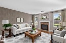 Recessed lighting, wood-finish flooring, and a fireplace with a mantel and arched alcove - 1850 Rutherford Road Sw, Edmonton, AB 