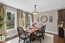 Wood-finish flooring, multiple windows, built-in cabinetry, pendant light fixture, and crown molding - 1850 Rutherford Road Sw, Edmonton, AB 