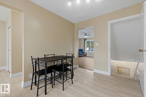 Neutral-toned walls complement wood-finish flooring - 11317 22 Avenue Nw, Edmonton, AB 