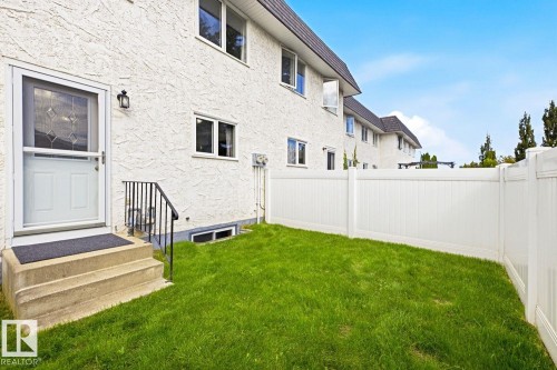 Private backyard space featuring a white vinyl fence - 11317 22 Avenue Nw, Edmonton, AB 