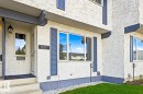 Stucco exterior with contrasting trim, permanent address numbering, and established landscaping - 11317 22 Avenue Nw, Edmonton, AB 