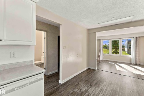 White cabinetry and an integrated dishwasher, complemented by a light-toned countertop - 17351 85 Avenue Nw, Edmonton, AB 