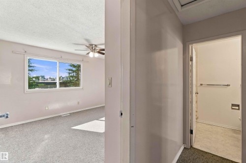 Room with light-colored carpeting, large window, and ceiling fan - 17351 85 Avenue Nw, Edmonton, AB 
