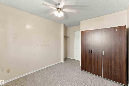 Textured ceiling with a ceiling fan light fixture - 17351 85 Avenue Nw, Edmonton, AB 
