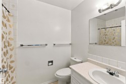 Bathroom featuring a vanity with a laminate countertop, integrated sink, and chrome faucet - 