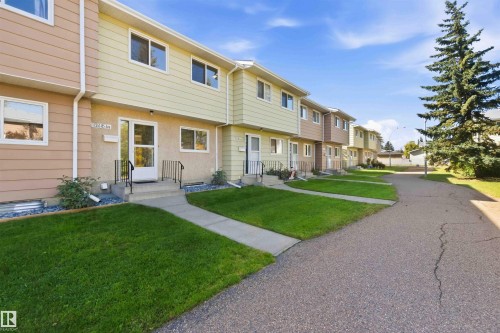 Multi-unit residential structure with individual entrances, front lawns, and paved pathways - 17351 85 Avenue Nw, Edmonton, AB 