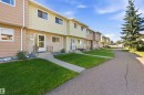 Multi-unit residential structure with individual entrances, front lawns, and paved pathways - 17351 85 Avenue Nw, Edmonton, AB 