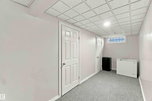 Finished lower level with paneled doors, carpet flooring, a drop ceiling, and a high window - 17351 85 Avenue Nw, Edmonton, AB 