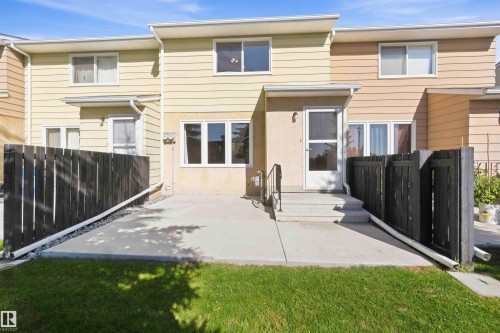 Paved patio with dark wood privacy fencing - 17351 85 Avenue Nw, Edmonton, AB 