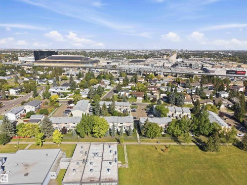 Expansive neighborhood setting with residential buildings, mature trees, and a nearby stadium - 17351 85 Avenue Nw, Edmonton, AB 