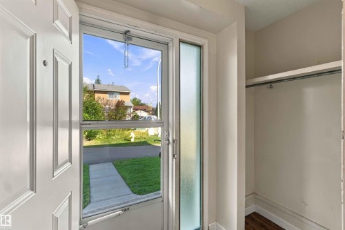 Entryway featuring a paneled door, screen door with clear glass, and a frosted sidelight - 17351 85 Avenue Nw, Edmonton, AB 