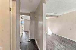 Wood-finish flooring throughout, with light-toned walls - 