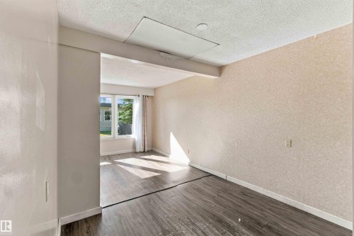 Recessed ceiling panel, textured wall finish, wood-finish flooring, and white trim - 17351 85 Avenue Nw, Edmonton, AB 