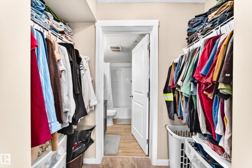 Walk-in closet with integrated shelving and hanging rods - #306 5370 Chappelle Rd Sw, Edmonton, AB 