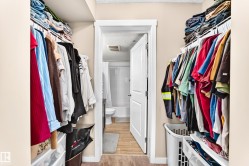 Walk-in closet with integrated shelving and hanging rods - 