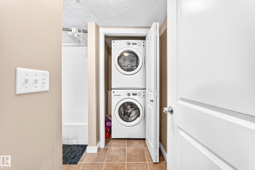 Stackable washer and dryer within a dedicated utility closet - #306 5370 Chappelle Rd Sw, Edmonton, AB 