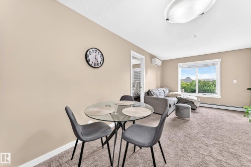 Carpeted living area with neutral wall tones and a window - #306 5370 Chappelle Rd Sw, Edmonton, AB 