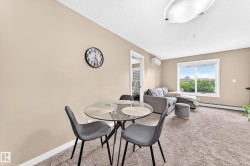 Carpeted living area with neutral wall tones and a window - 