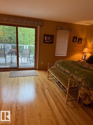 Hardwood flooring, sliding glass door, outdoor deck, window with blinds, and painted walls - 29 Lindbergh Crescent, St. Albert, AB 