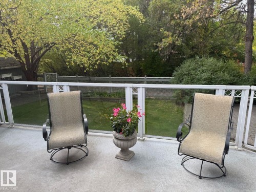 Expansive outdoor deck with a concrete surface and glass panel railing - 29 Lindbergh Crescent, St. Albert, AB 