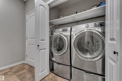 Laundry closet with tile flooring and built-in shelving - 