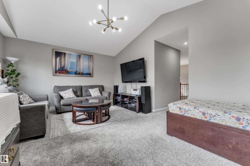 Vaulted ceiling with modern chandelier and recessed lighting - 3230 21A Avenue Nw, Edmonton, AB 