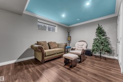 Recessed lighting, wood-finish flooring, white crown molding, and a light blue ceiling - 