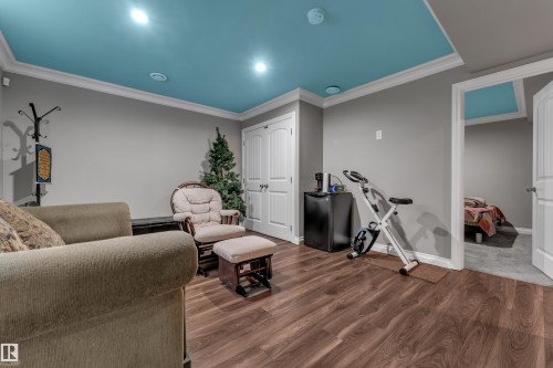 Wood-finish flooring, recessed lighting, crown molding, double-panel interior doors, and a built-in mini-fridge - 3230 21A Avenue Nw, Edmonton, AB 