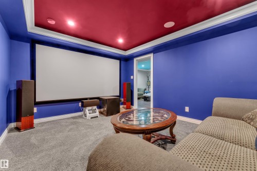 Recessed lighting, red ceiling with crown molding, wall-mounted projection screen, and gray carpeted flooring - 3230 21A Avenue Nw, Edmonton, AB 
