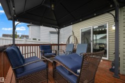 Expansive outdoor deck with a permanent pergola structure, integrated string lighting, and direct access through a sliding glass door - 