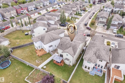 Fenced backyard featuring a wood deck, lawn space, and hardscaping - 3230 21A Avenue Nw, Edmonton, AB 