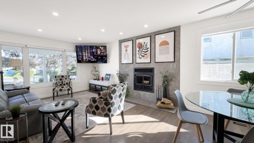 Open-concept living space with wood-finish flooring, recessed lighting, and a modern ceiling fan - 3508 106A Street Nw, Edmonton, AB 