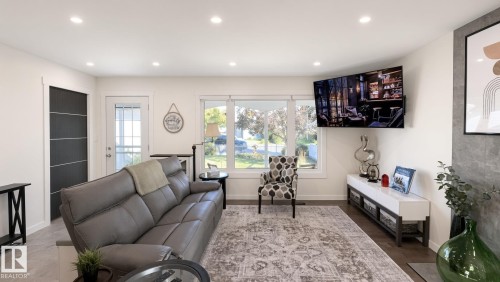 Recessed lighting, wood-finish flooring, white trim, and a glass-paneled exterior door - 3508 106A Street Nw, Edmonton, AB 