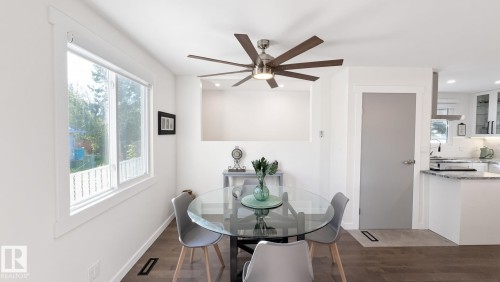 Expansive window, modern ceiling fan, wood-finish flooring, recessed lighting, and built-in shelving - 3508 106A Street Nw, Edmonton, AB 