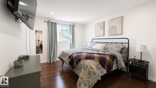 Hardwood-finish flooring, recessed lighting, white walls, and a window with neutral drapery - 3508 106A Street Nw, Edmonton, AB 