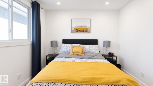 Recessed lighting, window with white trim, dark fabric headboard, wood-finish flooring, white walls - 3508 106A Street Nw, Edmonton, AB 