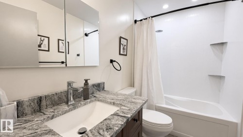 Vanity with granite-style countertop and integrated sink - 3508 106A Street Nw, Edmonton, AB 