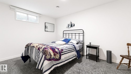 Recessed lighting illuminates the room, featuring a window with a white frame and white walls - 3508 106A Street Nw, Edmonton, AB 
