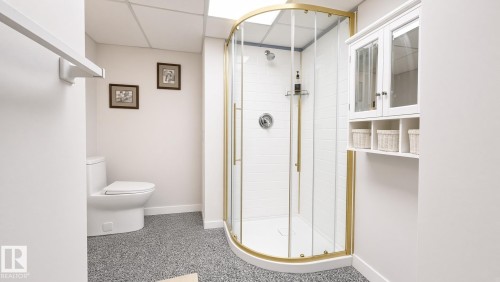 Glass-enclosed shower with gold-tone framing and hardware - 3508 106A Street Nw, Edmonton, AB 