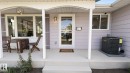 Covered front porch with white columns, light-colored siding, and a glass-paneled entry door - 3508 106A Street Nw, Edmonton, AB 