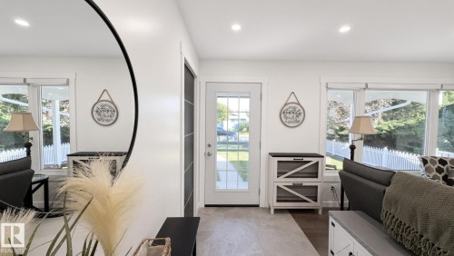 Recessed lighting illuminates the entryway and living area - 3508 106A Street Nw, Edmonton, AB 
