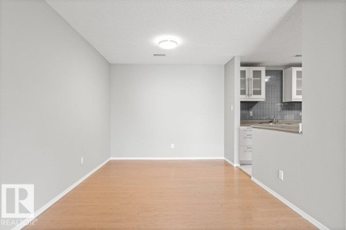 Light wood-finish flooring with neutral wall paint - #4 14620 26 St Nw, Edmonton, AB 