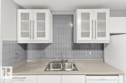 White upper cabinetry with frosted glass inserts - 