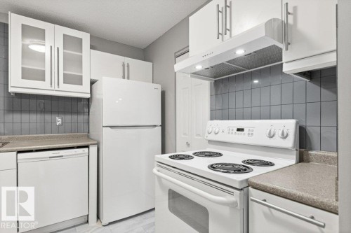 Contemporary kitchen featuring white cabinetry, a full-size refrigerator, an electric range with overhead exhaust hood, a dishwasher, and a tiled backsplash - #4 14620 26 St Nw, Edmonton, AB 