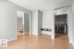 Wood-finish flooring throughout, with light gray painted walls - 