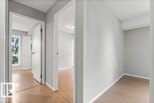 Wood-finish flooring throughout, white trim, and light grey wall finishes - #4 14620 26 St Nw, Edmonton, AB 