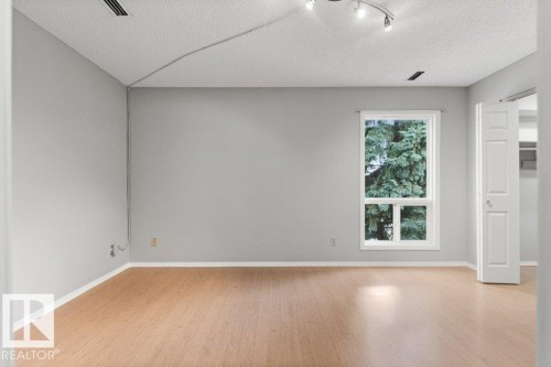 Wood-finish flooring with white trim - #4 14620 26 St Nw, Edmonton, AB 